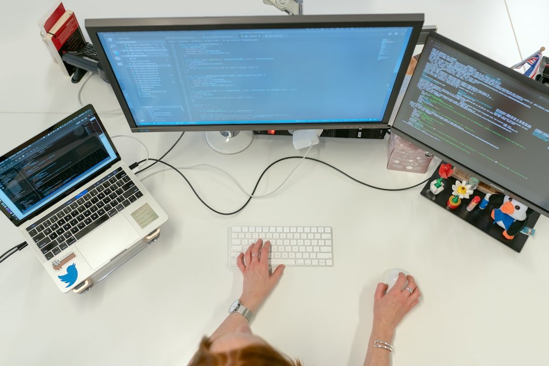 services-01 Female software engineer codes at her desk with computers